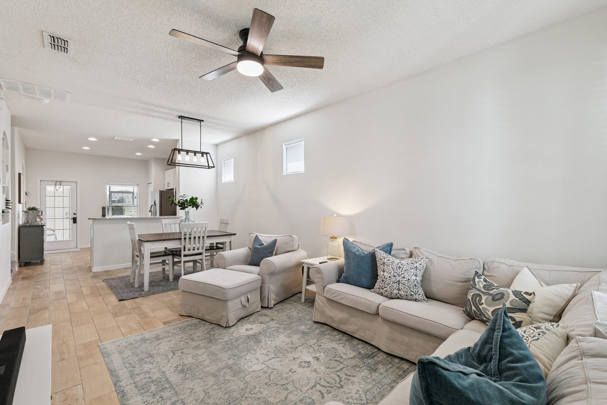 Living and dining space flowing to the kitchen in an open-concept plan at 13449 Carroway St, Windermere