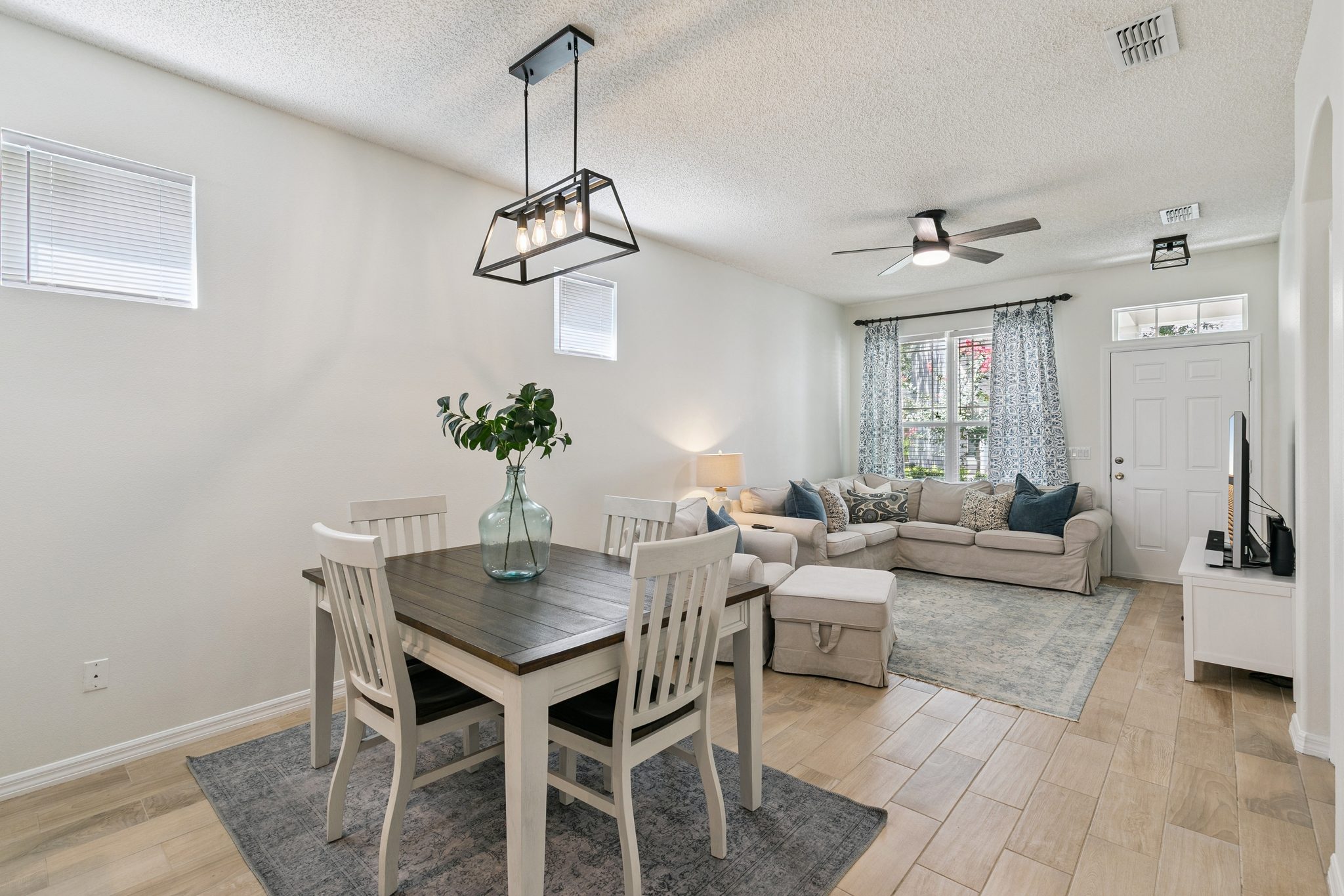 Dining area with a modern pendant light beside the living room at 13449 Carroway St, Windermere