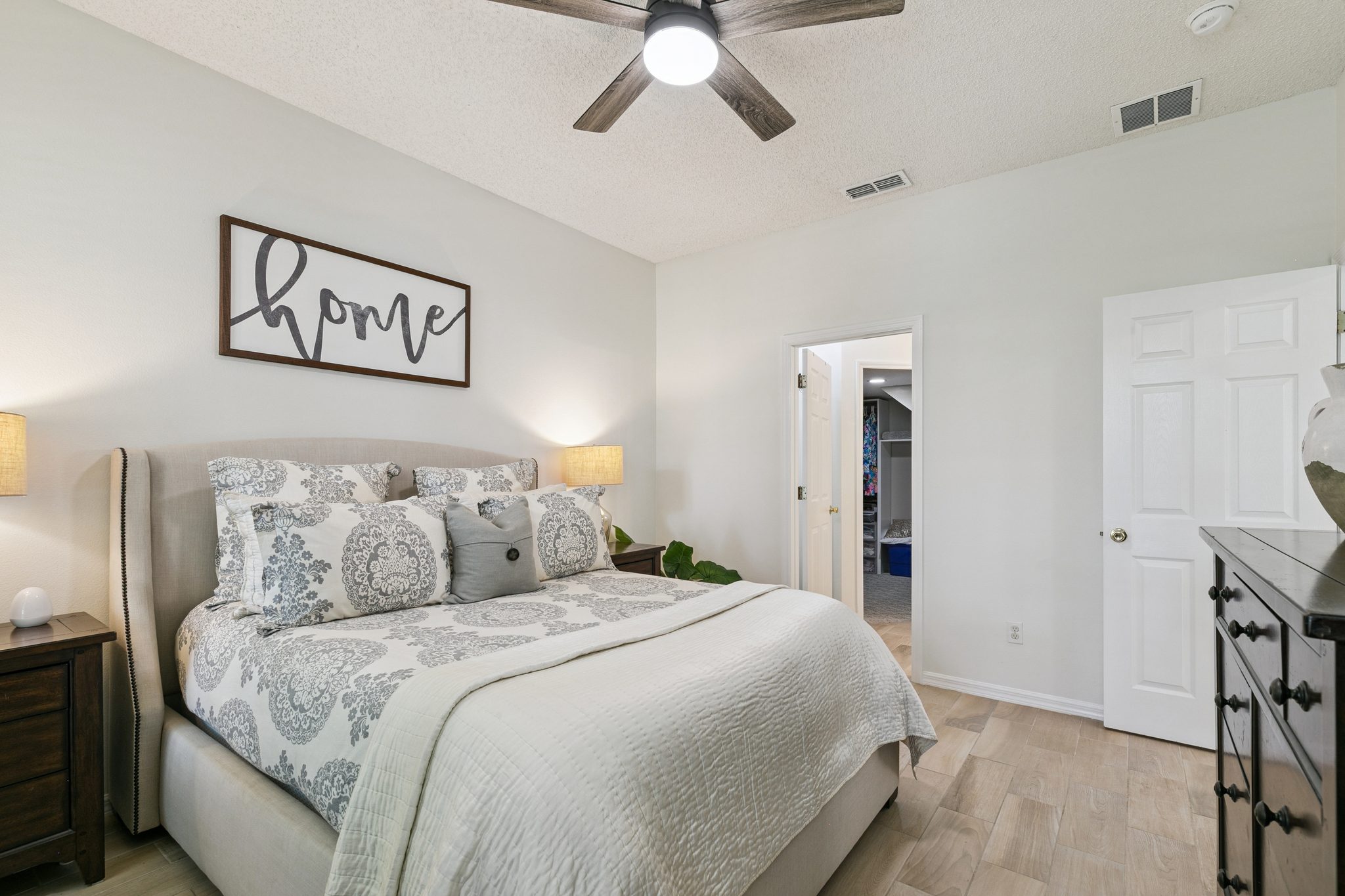 Spacious primary bedroom with a ceiling fan and en-suite access at 13449 Carroway St, Windermere