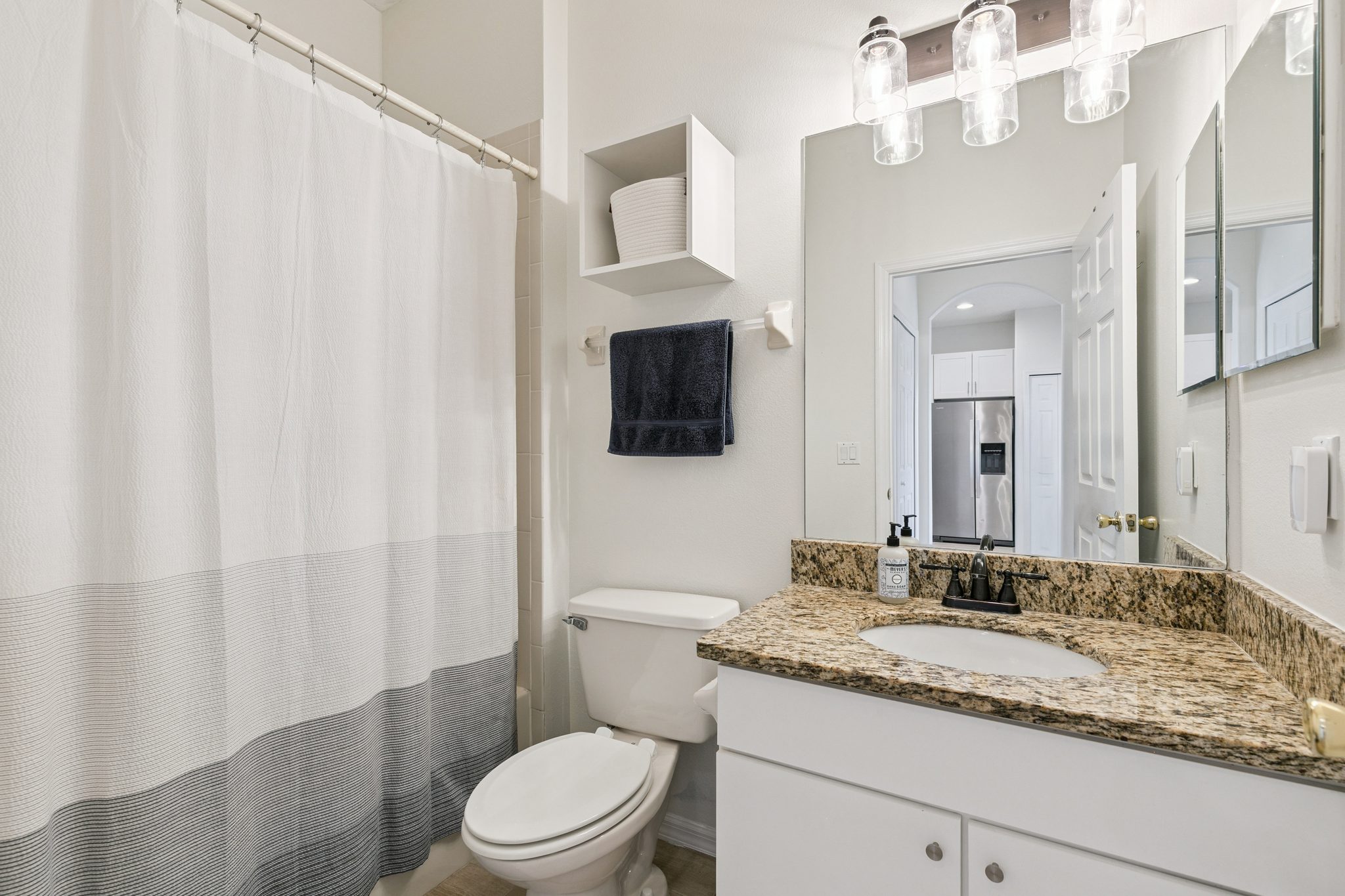 Full bathroom with a shower-tub combination and granite vanity at 13449 Carroway St, Windermere
